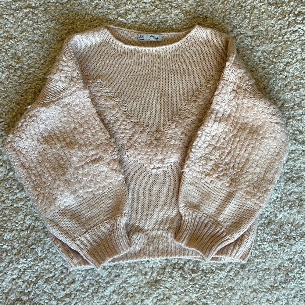 Soft pink winter pull over with intricate knitted detail.